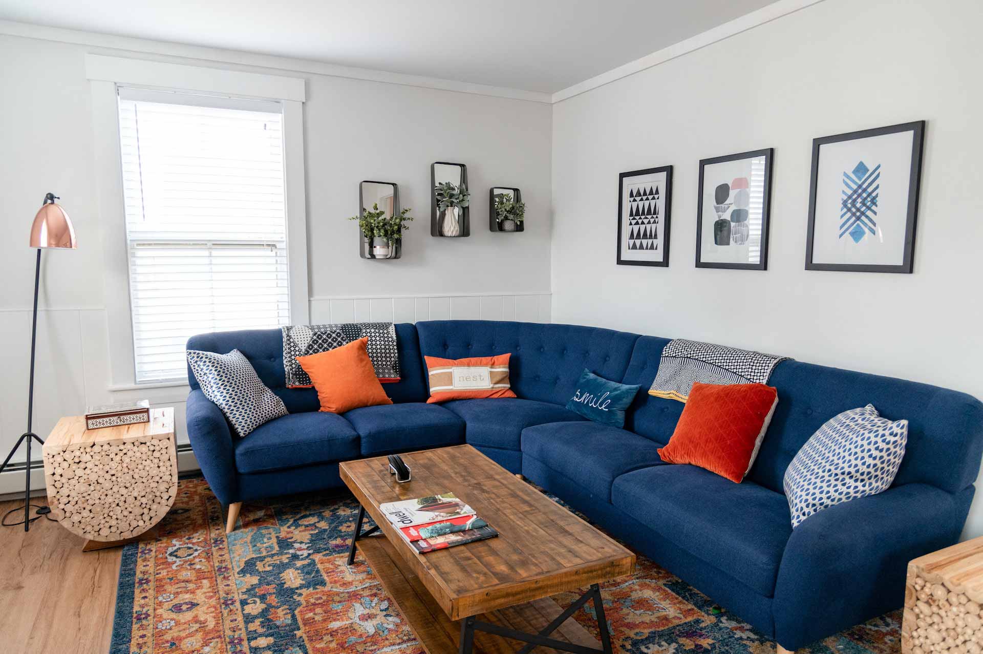 a living room with a blue couch and a coffee table