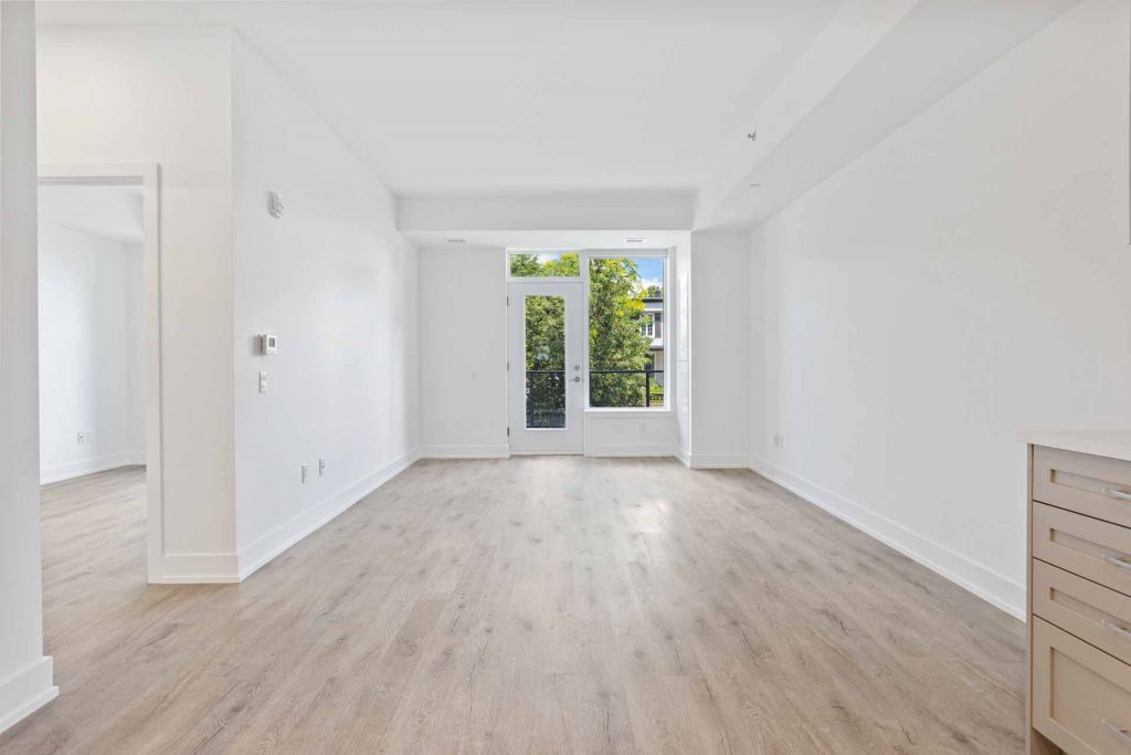Empty room with white walls and wood floor