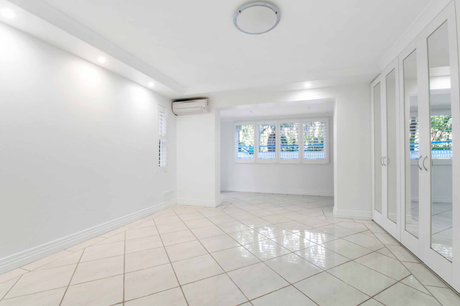 Empty room with white walls and white tile floor