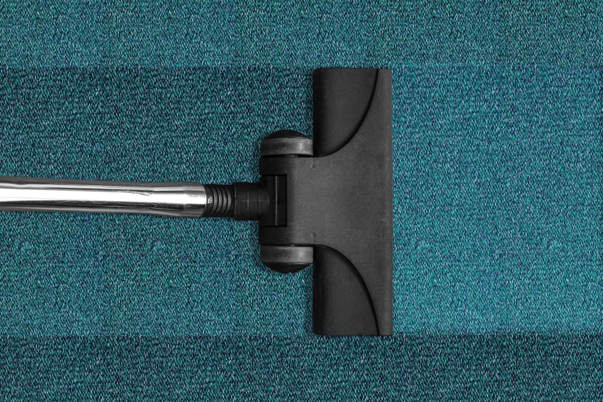 Vacuum cleaner on blue carpet